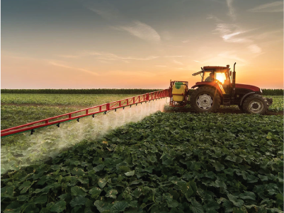 Farmer crop dusting his field at sunrise